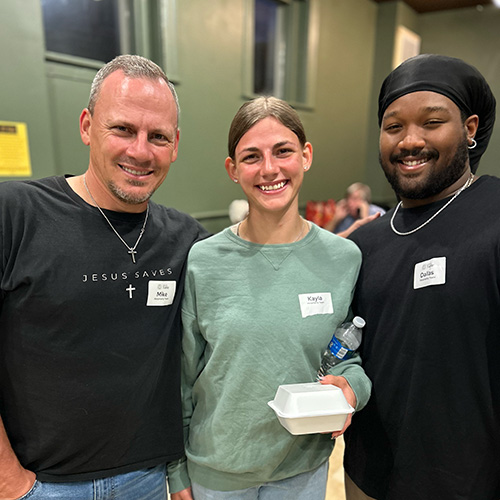 Three volunteers serving